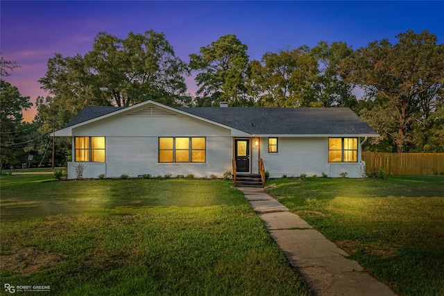 ranch-style house featuring a yard