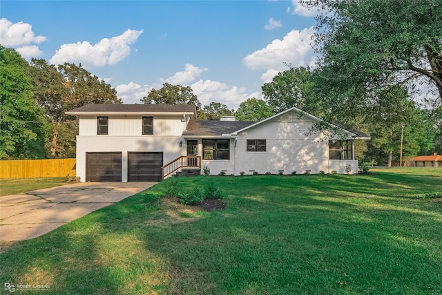 split level home featuring a garage and a front lawn