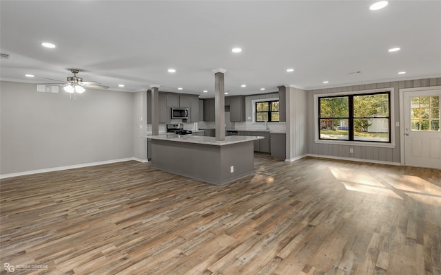 kitchen featuring sink, ceiling fan, gray cabinets, light stone countertops, and appliances with stainless steel finishes