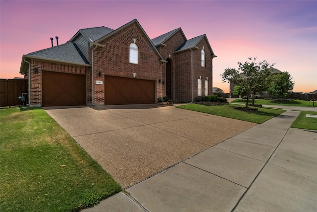 view of front of home with a lawn and a garage