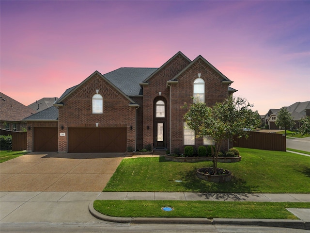 view of front of property with a lawn and a garage