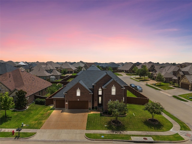 ranch-style house featuring a lawn and a garage