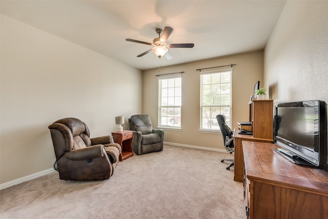 office area featuring light carpet and ceiling fan