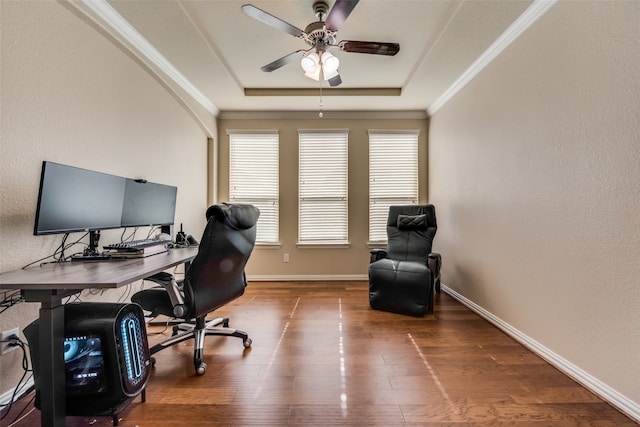 home office featuring ornamental molding, a tray ceiling, ceiling fan, and hardwood / wood-style flooring