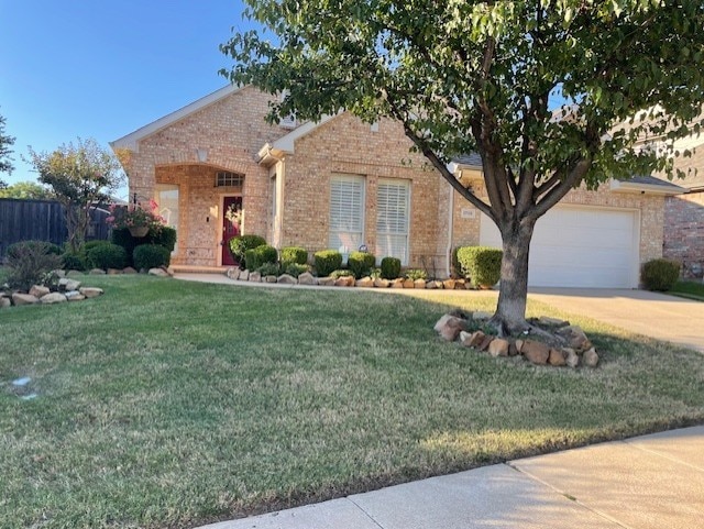 view of front of property featuring a garage and a front lawn