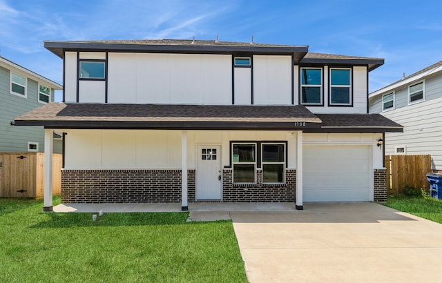 view of front of property with a porch, a garage, and a front yard