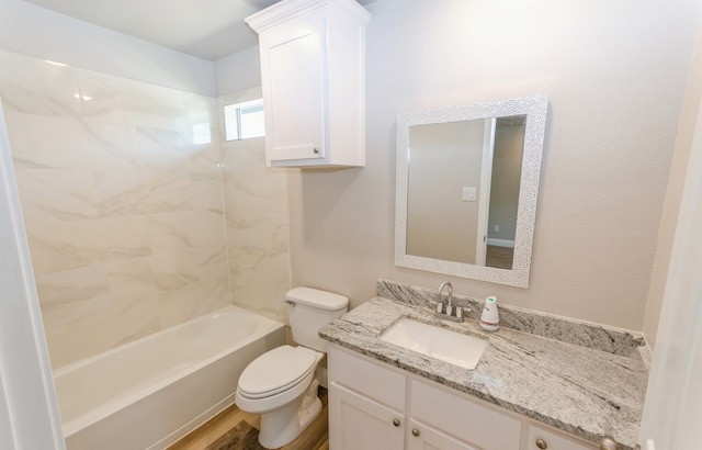 full bathroom featuring tiled shower / bath combo, vanity, hardwood / wood-style floors, and toilet