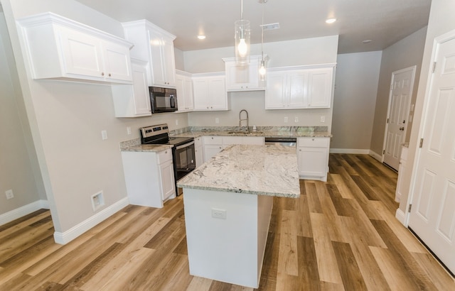 kitchen with white cabinets, sink, a center island, electric stove, and light hardwood / wood-style floors