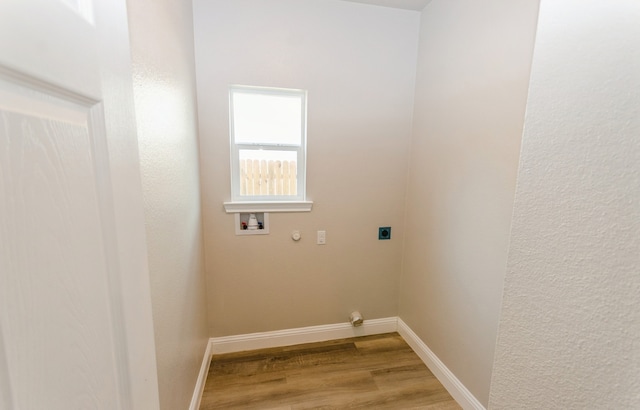 washroom featuring hookup for a washing machine, hardwood / wood-style floors, and electric dryer hookup