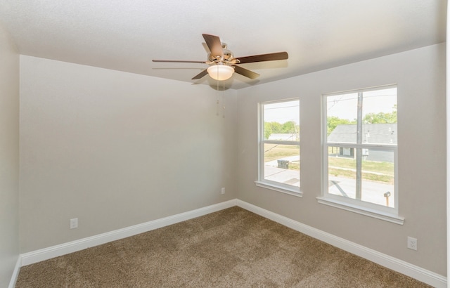 empty room featuring ceiling fan and carpet flooring