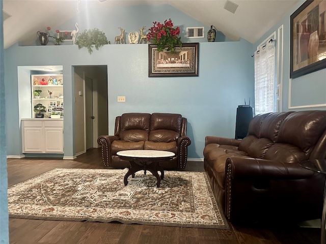 interior space featuring vaulted ceiling and dark hardwood / wood-style flooring