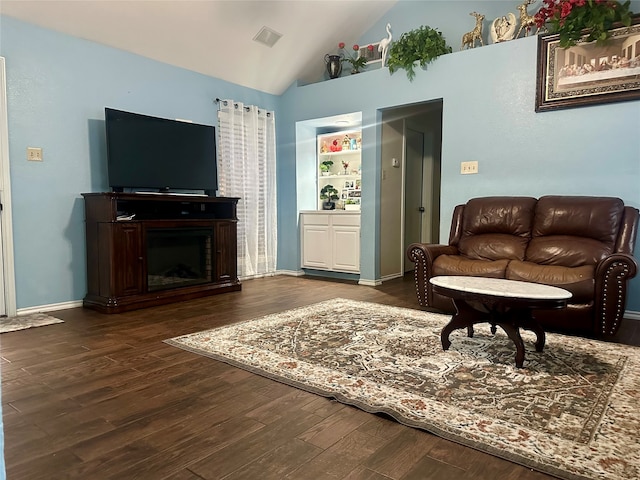 interior space with vaulted ceiling and dark wood-type flooring