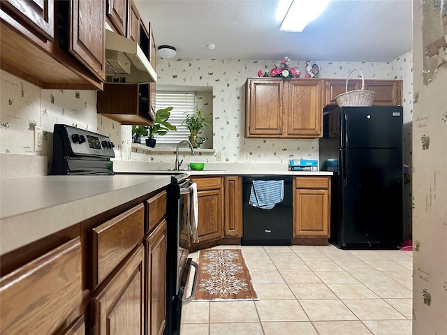 kitchen featuring light tile patterned floors and black appliances