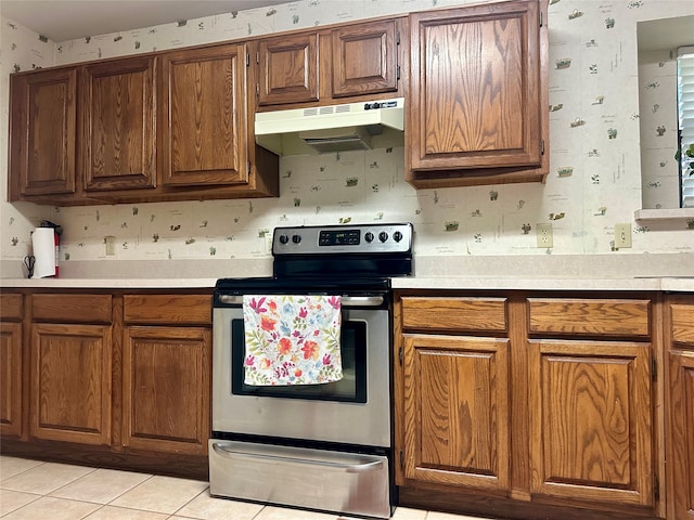 kitchen with stainless steel electric range oven and light tile patterned floors