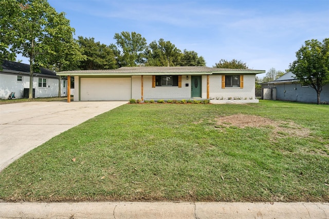 ranch-style house featuring a garage and a front yard