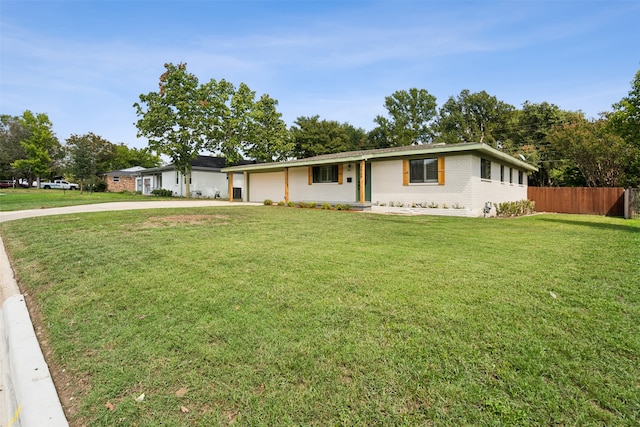 ranch-style house featuring a front yard and a garage