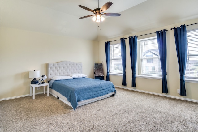 carpeted bedroom featuring lofted ceiling and ceiling fan