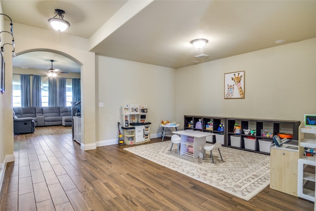 playroom with hardwood / wood-style floors and ceiling fan