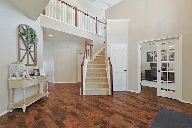 foyer with ceiling fan, dark wood-type flooring, and high vaulted ceiling