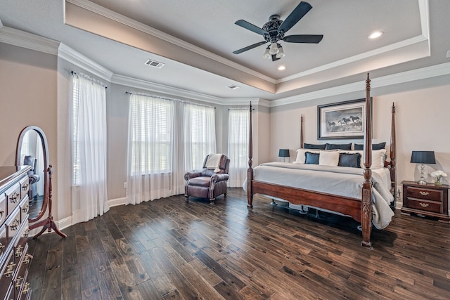 bedroom with a raised ceiling, ornamental molding, dark hardwood / wood-style floors, and ceiling fan