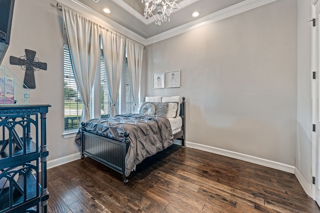 bedroom featuring ornamental molding, dark hardwood / wood-style floors, and a chandelier