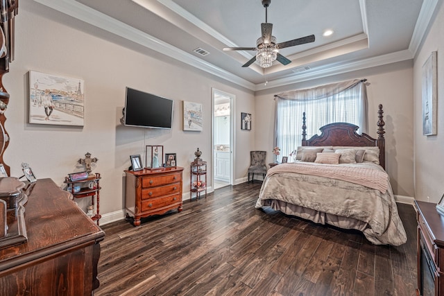 bedroom featuring visible vents, ornamental molding, dark wood finished floors, a tray ceiling, and recessed lighting