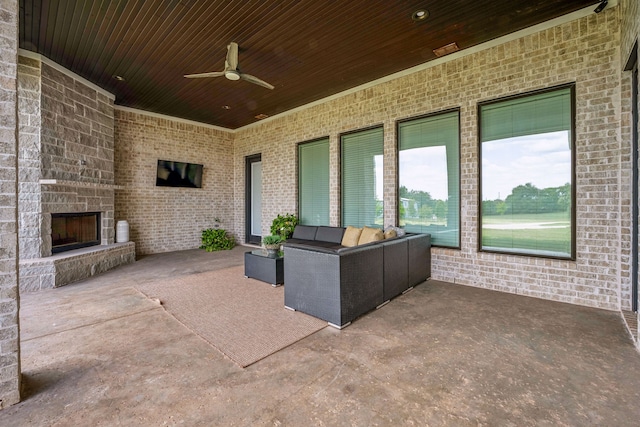 view of patio / terrace featuring an outdoor stone fireplace and ceiling fan