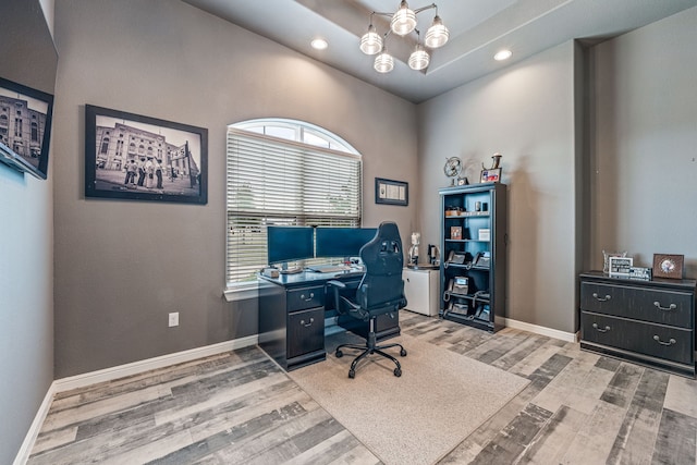 office with an inviting chandelier and light hardwood / wood-style floors