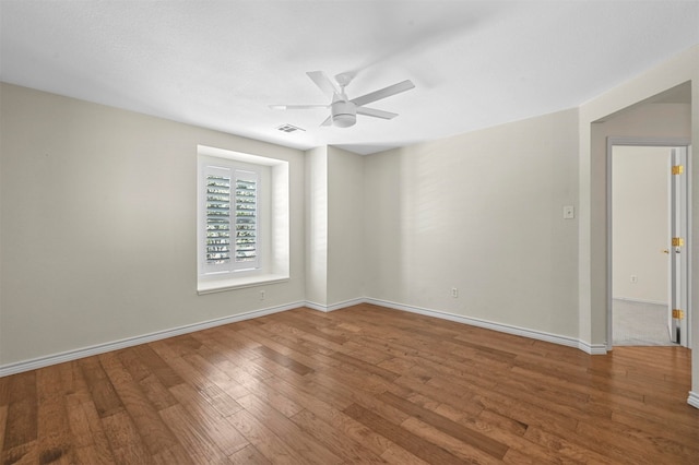 spare room with ceiling fan and wood-type flooring