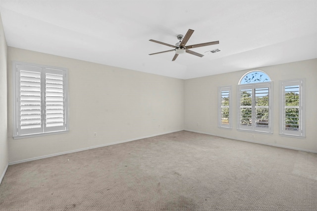 carpeted empty room featuring ceiling fan