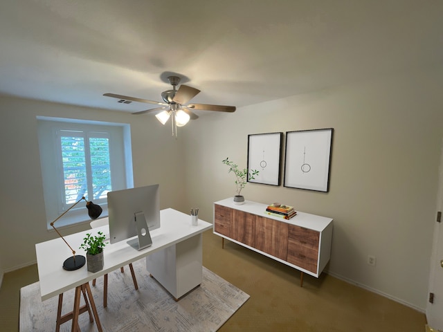 home office with dark carpet and ceiling fan