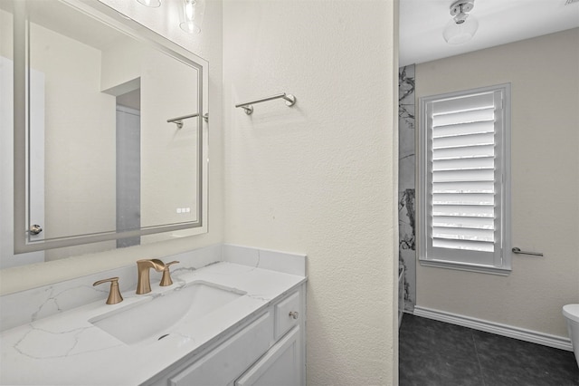 bathroom with vanity, toilet, and tile patterned floors