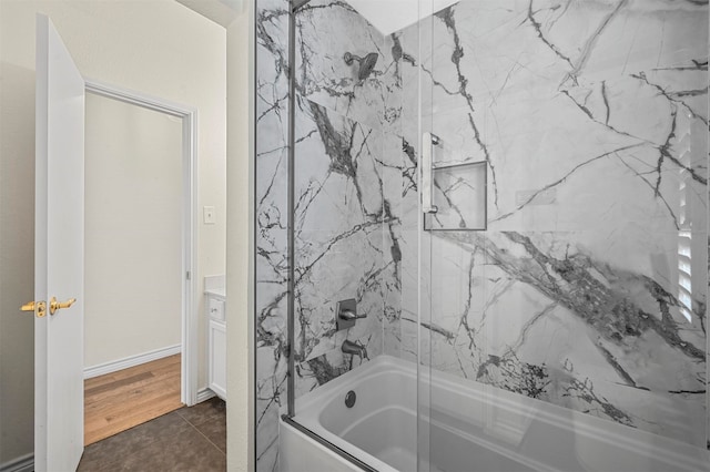 bathroom with vanity, tiled shower / bath, and tile patterned flooring