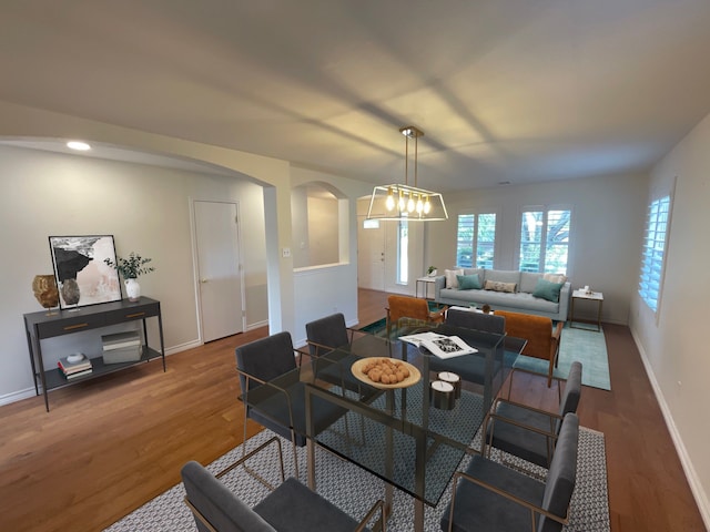 dining room with a notable chandelier and hardwood / wood-style flooring