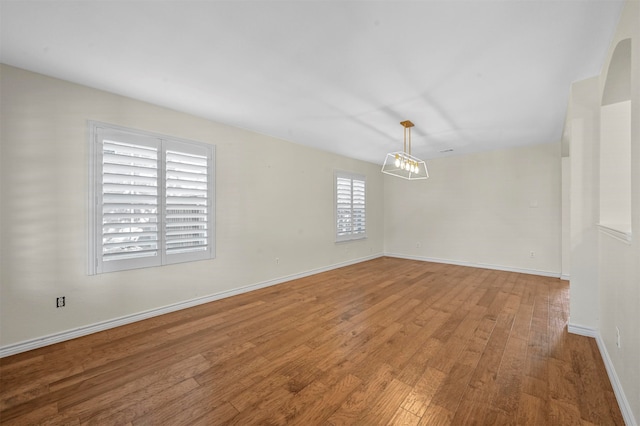 empty room with hardwood / wood-style flooring