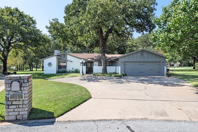 ranch-style home with a front yard and a garage