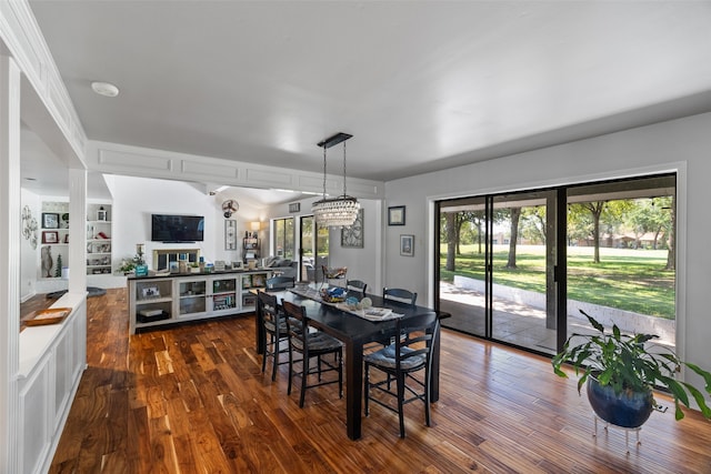 dining space featuring dark hardwood / wood-style floors and a chandelier