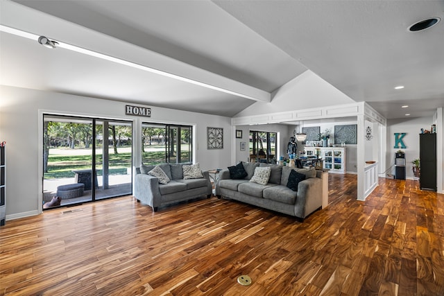 living room featuring wood-type flooring and vaulted ceiling with beams