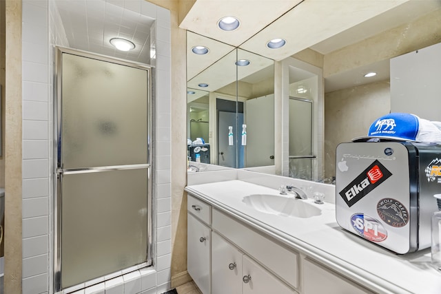 bathroom featuring an enclosed shower and vanity