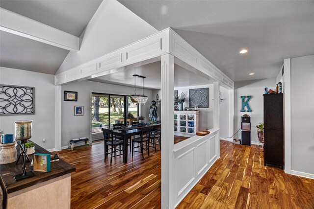 kitchen with vaulted ceiling with beams, dark hardwood / wood-style flooring, and white cabinetry