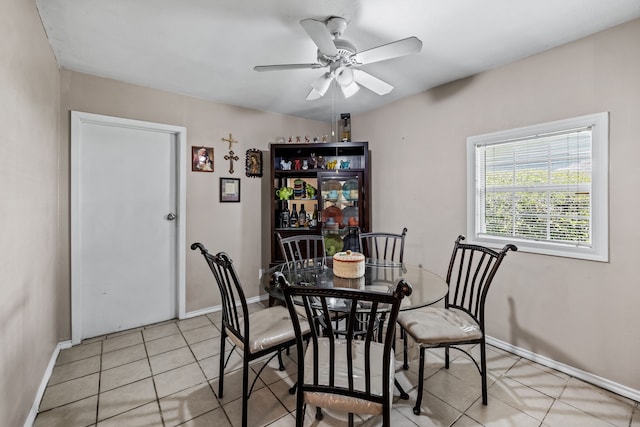 dining space featuring ceiling fan and light tile patterned flooring