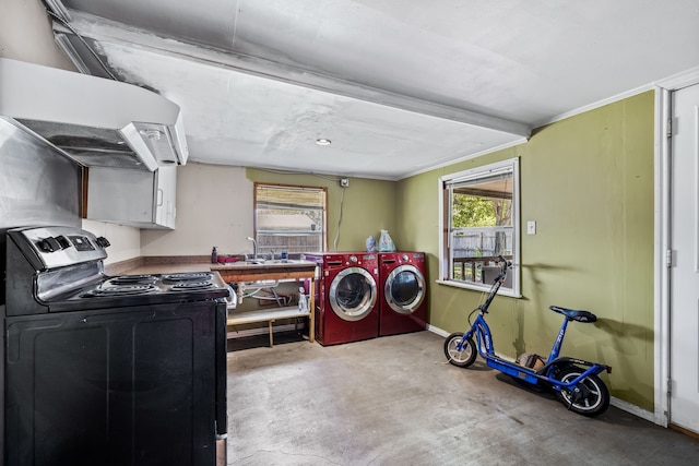 laundry room with crown molding and washing machine and dryer