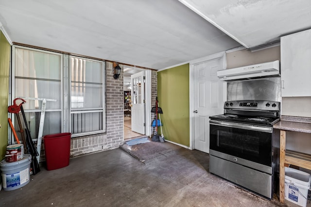 kitchen featuring electric stove, concrete flooring, and range hood