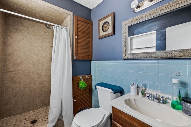 bathroom featuring tile walls, vanity, toilet, and a shower with curtain