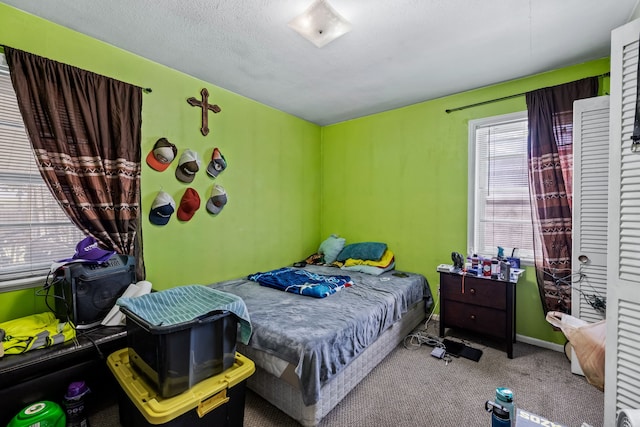 carpeted bedroom with a textured ceiling