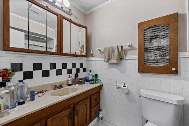 bathroom featuring vanity, tile walls, crown molding, and toilet