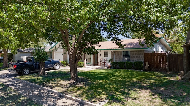 view of front of property featuring a garage and a front lawn