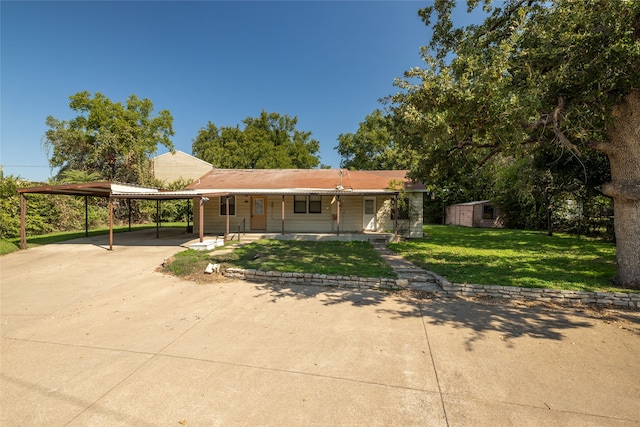 view of front of house featuring a carport, a front lawn, and covered porch