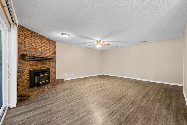 unfurnished living room featuring a textured ceiling, wood-type flooring, and ceiling fan