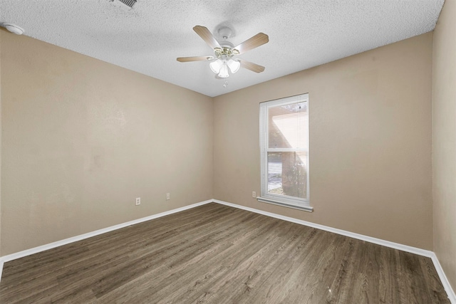 empty room featuring a textured ceiling, ceiling fan, and dark hardwood / wood-style flooring